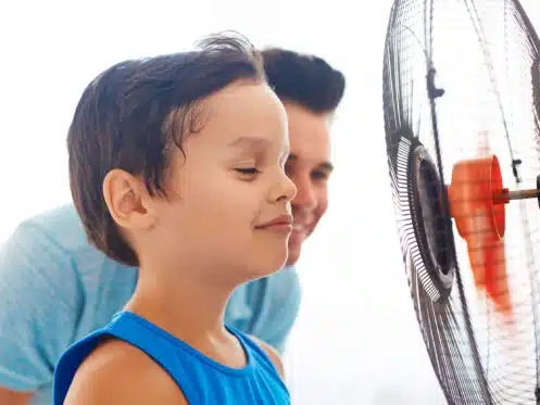 kid infront of a fan