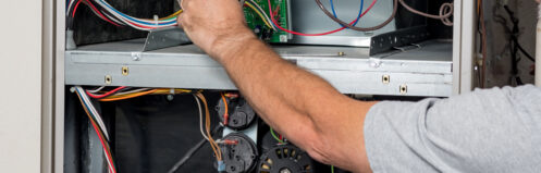 An HVAC tech working on a furnace