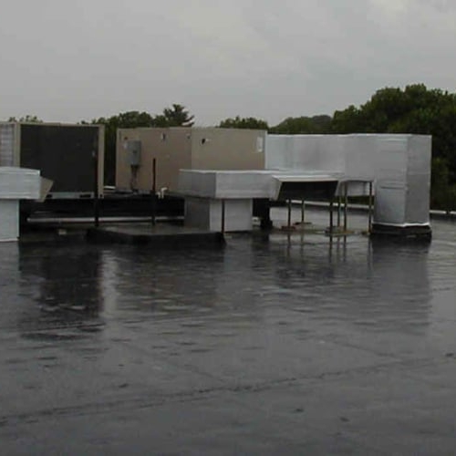 Commercial HVAC Unit on the roof of building in the rain