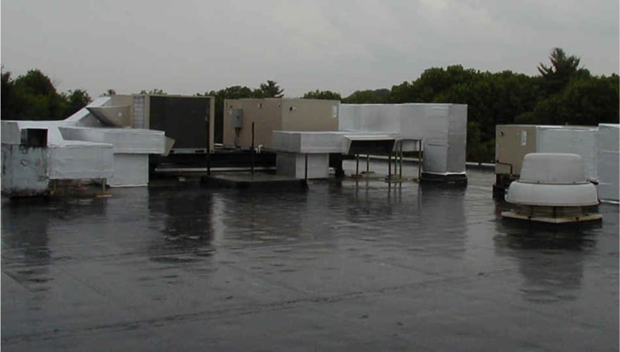 Commercial HVAC Unit on the roof of building in the rain