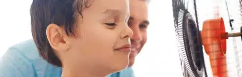 kid infront of a fan