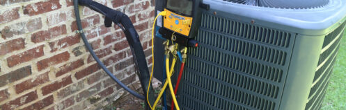 An AC unit getting maintenance in Nashua