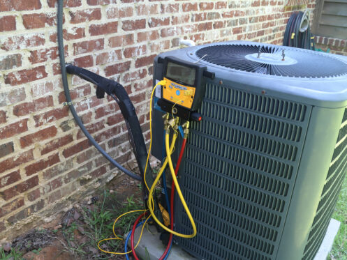 An AC unit getting maintenance in Nashua